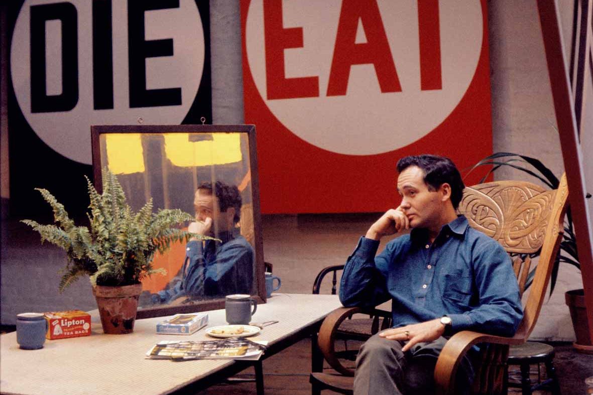 Robert Indiana with EAT/DIE (1962) in the background © William John Kennedy